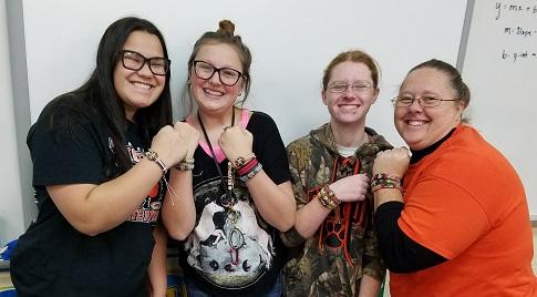 StuCo members and Mrs. Ebens showing bands